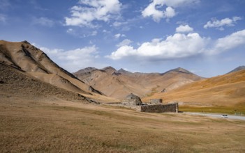 Historic caravanserai Tash Rabat from the 15th century, with yellow hills, Atbashy district in the