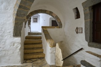 Interior of a historic monastery with stone stairs and arches, Inside the monastery, Agiou