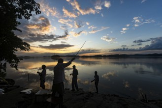 People fishing in the Brahmaputra river at the background during the sunset, in Guwahati, Assam,