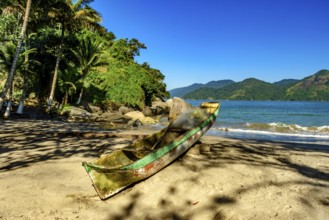 Fishing canoe over beach sandof Castelhanos beach in Ilhabela, Castelhanos beach, Ilhabela, Sao