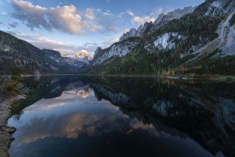 The Vordere Gosausee lake in autumn with a view of the Dachstein mountain range. The Gosaukamm on