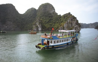 Excursion boat and the karst rocks in Lan Ha Bay, Halong Bay, Vietnam, Asia