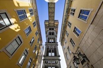 View from below of the Santa Justa Lift, an historical elevator in Lisbon, contrasting with the