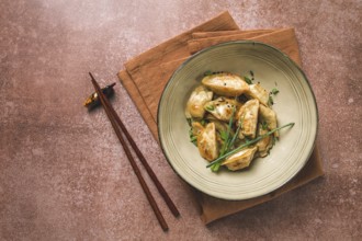 Japanese fried gyoza dumplings, with pork, sesame seeds, green onions