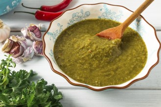 Tkemali sauce, traditional Georgian cuisine, green cherry plum, with ingredients for sauce,