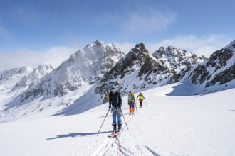 Ski tourer with rope, rope team on the Vadret da Porchabella glacier on the ascent to the summit of