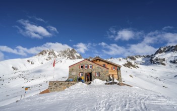 Chamanna d'Es-cha mountain hut in a wintry mountain landscape, Grisons Haute Route ski tour, Albula