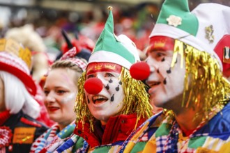 Colourfully costumed carnivalists celebrate carnival in Cologne, on Weiberfastnacht the street