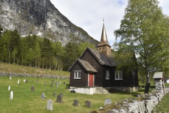 Wooden church with gravestones in Norway