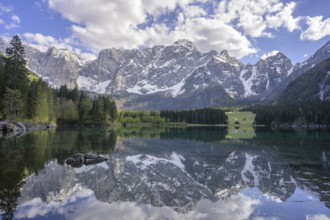 The Mangart mountain range reflected in Lake Fusine, Tarvisio, province of Udine, Italy, Europe
