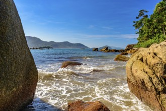 The sea between the stones of Bonete beach on the island of Ilhabela, Bonete beach, Ilhabela, Sao