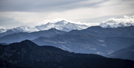 View of the Alpine foothills and the main Alpine ridge with snow-covered peaks, from the Austrian