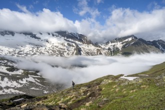Mountaineer on a hiking trail with high fog in the valley, summit Hochfeiler, Hoher Weißzint and