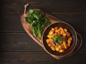 Potatoes stewed with meat, in tomato sauce, with spices and herbs, no people