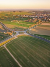 Aerial view of fields and roads in the morning light with a village in the background, Nagold,