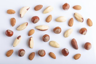 Pattern made from different kinds of nuts. isolated on white. hazelnut, brazil nut, almond, pumpkin