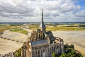 Aerial view of the imposing abbey in an extensive sand and water landscape, Le Mont-Saint-Michel