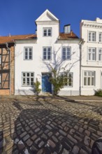 Historic house, dormer, façade with windows and door, street An der Obertrave made of cobblestones,