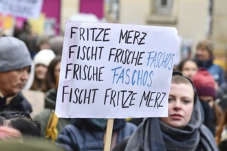 Heidelberg, Germany - February 12th 2025: Person holding up sign about CDU politian Merz and