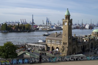 Clock tower, Landungsbrücken, harbour cranes in the harbour behind, St. Pauli, Hamburg, Germany,