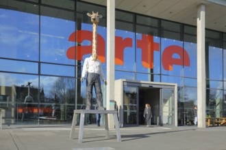 Entrance to the modern building of the ARD and ZDF broadcasting station Arte with sculpture Giraffe
