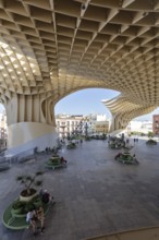 Modern architecture of the Metropol Parasol with people enjoying the shade in the square, Seville