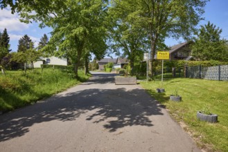 Entrance to the village with road and village sign for the district of Pesch, Nettersheim, Eifel,