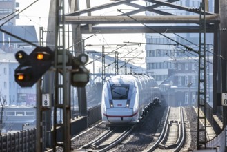ICE en route on a railway bridge with tracks and signalling system. Mannheim, Baden-Württemberg,
