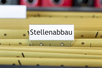 Sign with the inscription STELLENABBAU on a suspension file folder (symbolic image)