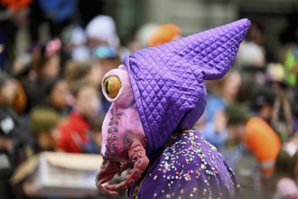 Person masked as an octopus at the carnival parade of the Wey guild on Rose Monday, Güdismäntig,