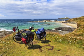 Two e-bikes on the South West Coast Path, coastline with Godrevy Island and lighthouse, landscape