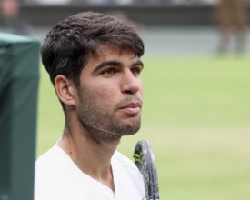 Spanish tennis player Carlos Alcaraz looking at his coach on the centre court at the 2024 Wimbledon