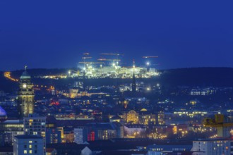 City centre of Dresden at blue hour, on the horizon the illuminated construction site of Infineon,