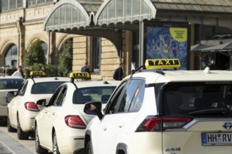 Taxis parked at a taxi rank in front of Dammtor train station in Hamburg, Germany, Europe