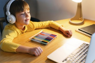 High view child taking virtual courses