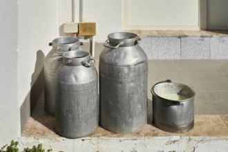 Some milk cans waiting to be taken away
