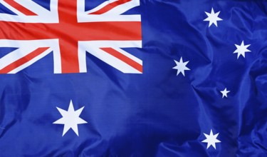Close-up of the national flag of Australia, fluttering in the wind with folds, wave pattern