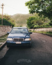 Old Mercedes car parked in village between Albanian mountaing