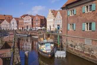 Harbour basin with railings, boats and the gabled houses, brick buildings and half-timbered houses