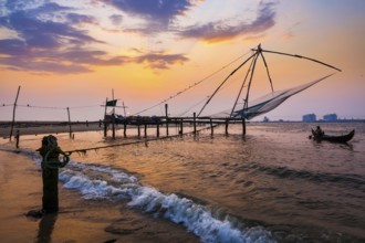 Kochi Chinese fishnets on sunset in Fort Kochin, Kochi, Kerala, India, Asia