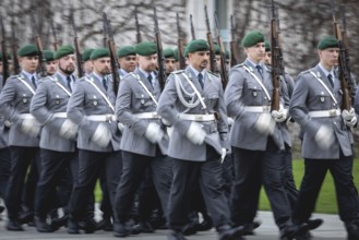 Army soldiers of the guard battalion march as part of an honour formation at the Chancellery in