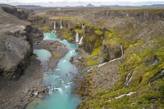 Waterfalls and a turquoise blue river flowing through a canyon, Sigöldugljúfur, long exposure,