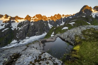 Rocky mountain peaks, small pond with cotton grass in moor landscape at Trollfjord Hytta, mountain