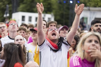Football fans in the fan zone at the Brandenburg Tor during the quarter-final match between Germany