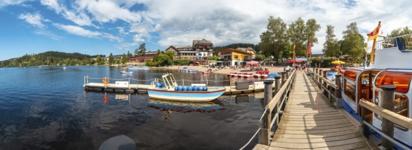 Panoramic view of the pier with tourists in summer on Lake Titisee in the Black Forest of Germany