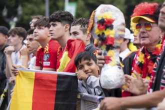 Spanish and German football fans next to each other in the front row of the fan zone at the