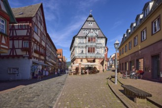 Inn and Hotel Zum Riesen with lantern and benches against blue sky with cirrostratus clouds in