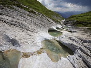 Glacier mill with glacier pots on the Trinser Alp Mora, Trin, Canton Graubünden, Switzerland,