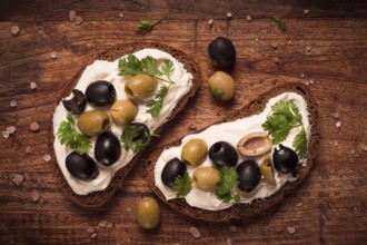 Breakfast, sandwiches, with cream cheese, olives, top view
