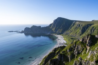 View of coastal landscape, cliffs with peak Måtind or Måtinden, Høyvika beach and sea, hike to the